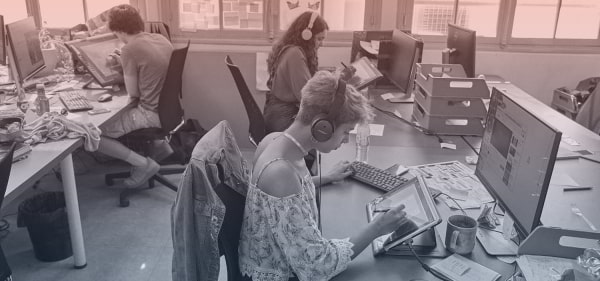 a group of designers working on a drawing tablets 